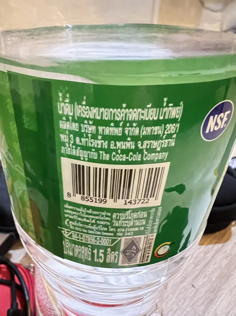 Back label of Namthip 1.5 litre drinking water showing Haad Thip manufacturer details, Thai FDA number, and barcode