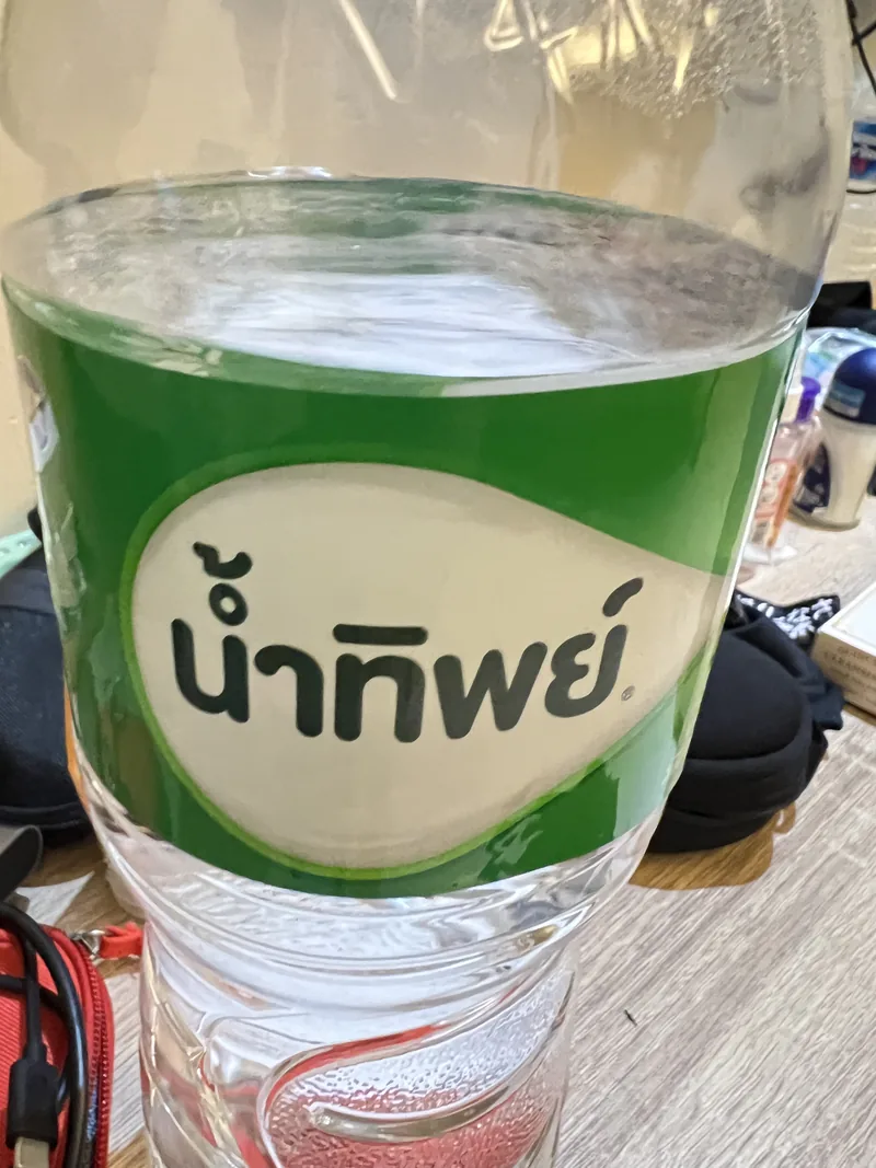 Close-up front label of a green Namthip 1.5 litre drinking-water bottle