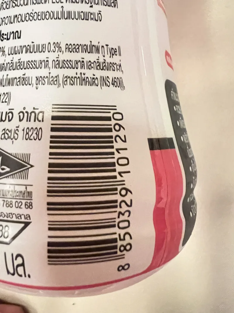 Side of the Meiji bottle showing ingredients, allergen text, and barcode 8850329101290