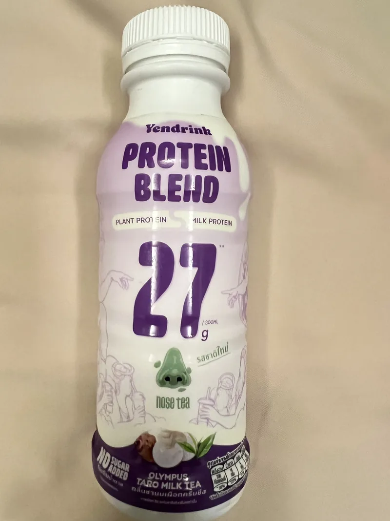 Front of a white and purple Yendrink Olympus taro milk-tea bottle declaring 27 grams of protein