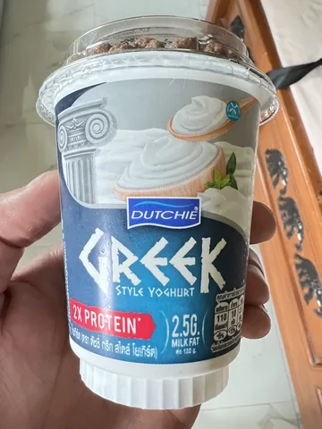 Photographed 120 gram Dutchie Greek Style 2X Protein original yogurt cup with its separate crunchy topping compartment